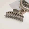 Macro detail of large matte grey-green shark hair clip with 11 pairs of interlocking teeth - Keel / Grey Brown