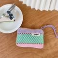 Striped knit makeup bag in purple and green with brand label on wooden surface - Blue & Green Stripes