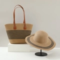 Close-up of woven straw tote and wide brim sun hat with elegant black stripe detail - Khaki Black Striped