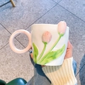 Close-up of white ceramic tulip mug with pink handle and hand-painted floral details - Single Cup / Pink
