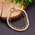 Detail of multi-layer bracelet with white pearls, gold chains and an OT toggle clasp - Three Layer White Pearl Bangle