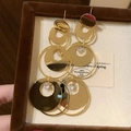 Multi-layered geometric golden hoop earrings with zircon crystals in a black jewelry box - Gold