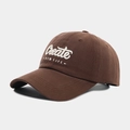 Detailed close-up of premium 3D embroidery showing Create New Life on a brown baseball cap - Coffee