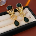Detailed view of vintage tiger head earrings with green teardrop pendants in a box - 43# Silver Pin-Gold-Black
