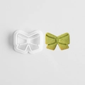 Bowtie shaped 3D cookie cutter in white plastic with matching green finished cookie - E0848-Bow