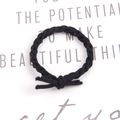 Elastic braided hair tie in solid black color on a minimalist white background - Black