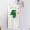 Green dinosaur number 4 birthday candle with white dots and back fin details - Number 4
