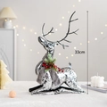 Elegant 33cm silver reindeer figurine with festive wreath and warm bokeh background - Classic Kneeling Deer with Black Feet (33cm)