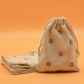 Beige cotton drawstring sachet bag with dark floral print for jewelry or gift - Coffee Daisy