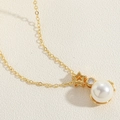 Detailed macro shot of a gold necklace featuring star, zircon, and large pearl pendant - Pentagram Pearl Pendant Necklace (Gold)