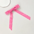 Detailed view of pink velvet bow hair clip with white piped edges on elegant display - Rose Red