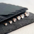 Detailed view of six pairs of rose gold sparkling zircon stud earrings on black rock - 3mm Pair / Rose Gold