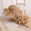 Detail of straw sun hat and crossbody bag set featuring colorful fuzzy pompoms - Khaki Hat + Bag