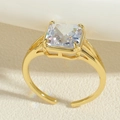 Detail of a gold adjustable ring featuring a square clear zircon stone in a close-up shot - Adjustable Open / Gold Square