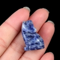 Hand-carved sodalite wolf figurine showing natural blue and white stone patterns - Blue Spot Stone
