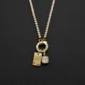 Stainless steel necklace with letter F pendant and square rhinestone in golden finish - Letter F (XNL0116)