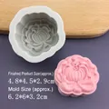 Macro detail of lotus flower silicone mold with finished pink clay sample for soap making - Chrysanthemum