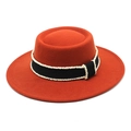 Detail of rust orange wool felt boater hat with black ribbon and white pearl trim - Rust red