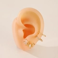 Gold leaf-shaped stud earrings and cubic zirconia ear cuffs set on a silicone ear model - Gold (DZ-640)