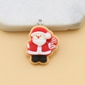 Macro shot of a resin Santa Claus pendant with a metal ring for DIY jewelry making - Santa Claus