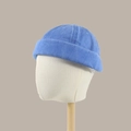 Blue washed cotton docker cap with rolled brim and breathable eyelets on display stand - Sapphire Blue