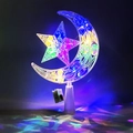 Glow of illuminated transparent plastic moon and star lamps on white base in dark setting - 15cm Polka Dot Star Moon Multicolor (Button Battery)