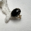 Detailed macro of handmade 14K gold wire wrapped ring with oval black tiger eye gemstone - Black Agate