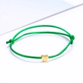 Adjustable green cord bracelet featuring a minimalist golden heart charm on a white surface - Green Gold