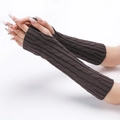 Detail view of dark brown cable knit arm warmers with fingerless design on a model - Dark Gray