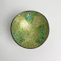 Macro view of green and gold mosaic inlay on a decorative Vietnamese coconut shell bowl - Green Pomegranate Style