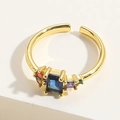 Detailed view of golden open ring with large blue rectangular stone and colorful zircons - JZ0317-1 Blue Zirconia Open Ring / Blue Zirconia
