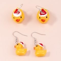 Detail view of yellow duck earrings with red Christmas hats and metal ear hooks - Christmas Hat Style