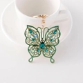 Sparkling green rhinestone butterfly keychain with gold plating and ornate crystal wings - Green