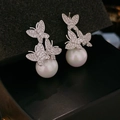 Macro detail of silver butterfly stud earrings with sparkling pavé zircons and pearls - E1134-Silver Butterfly Pearl