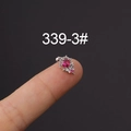 Silver stainless steel ear stud with red zircon crown design held on a fingertip - Silver Red Zircon Style (HSPJ339-3#)