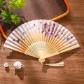 Traditional Chinese folding fan with hand-painted peony patterns and light yellow tassel - 19 Heavenly Beauty