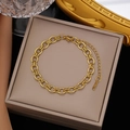 Detail view of 18k gold plated stainless steel double ring chain bracelet on jewelry box - Gold Stainless Steel Handmade Link Bracelet (SLE2026)