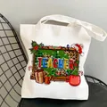 White canvas tote bag for teachers featuring colorful Christmas theme graphic and text - Style C4