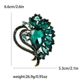 Vintage heart-shaped brooch with emerald green teardrop crystal and golden metal base - Green