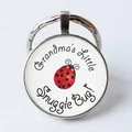 Detail of round key ring with Grandma's Little Snuggle Bug ladybug illustration - Ladybug/Grandma's Snuggle Bug