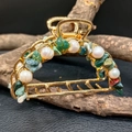 Close-up of golden metal hair claw with natural green stones and white pearls - Indian Agate + Deep Sea Pearl Gold Hair Claw