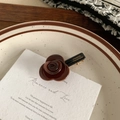 Detail of a vintage-style chocolate rose hair clip with France Handmade gold lettering - Brown