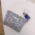 Detail of floral makeup bag with simple wish label on soft quilted background - Fresh Blue Floral