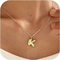 Minimalist gold necklace with letter K pendant worn on neck with polished finish - Gold K
