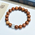 Brown wooden beaded bracelet with white jade stone bead on a minimalist background - Burma Pearwood 10mm Single Circle With Jade