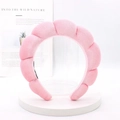 Detail shot of a soft pink padded sponge headband for face washing and SPA routine - Pink