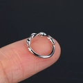 Minimalist silver twisted zircon ring for nose or cartilage shown on fingertip - Silver (CC094-1)