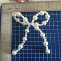 Close-up of white faux pearl bow accessory with scale ruler showing 10x11cm size - Alternating Pearl Large