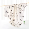 Bamboo cotton swaddle blanket with swallow and feather prints on a creamy white base - Swallow