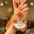 Cute brown plush capybara keychain with white apron and bread decor on orange lanyard - Lieba Bread Headband Apron